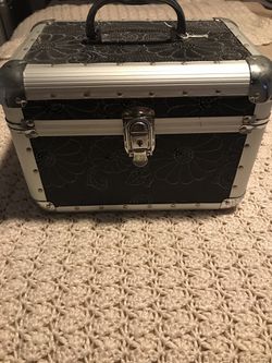 Small case with lock & it has a shelf inside it also has glitter flowers on the case