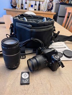 Canon EOS Rebel XS 35mm SLR film Camera 35-80mm f/4-5.7 zoom lens attached W/ Canon EF 75-300mm f/4-5.9 III Telephoto Zoom Lens