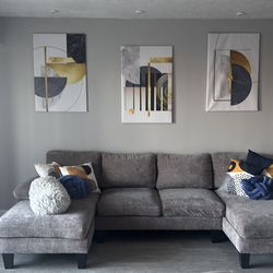 Sectional couch with pillows and paintings set