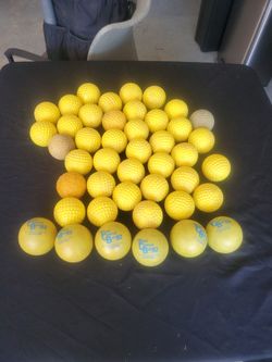 40 dimpled pitching machine balls and 6 weight balls