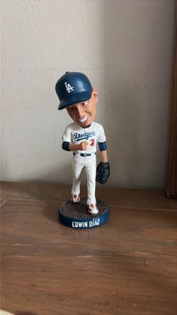 This collectible is a 2026 Los Angeles Dodgers Edwin Díaz bobblehead featuring a specialized blue base with his name.