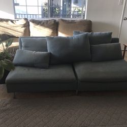 Beautiful Blue Couch With Cushions And Sideboard