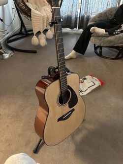 Yamaha acoustic guitar with stand