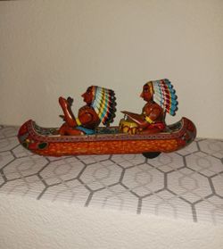 vintage "Tom Tom Indian" friction canoe toy