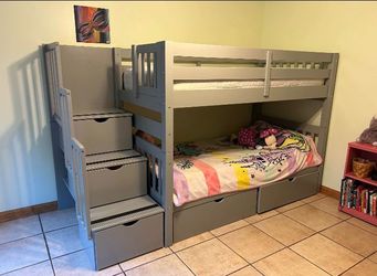 Bunk bed with mattresses and staircases