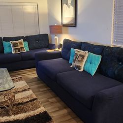 Large Beige Sofas  With Blue Slip Covers and Pillows. 