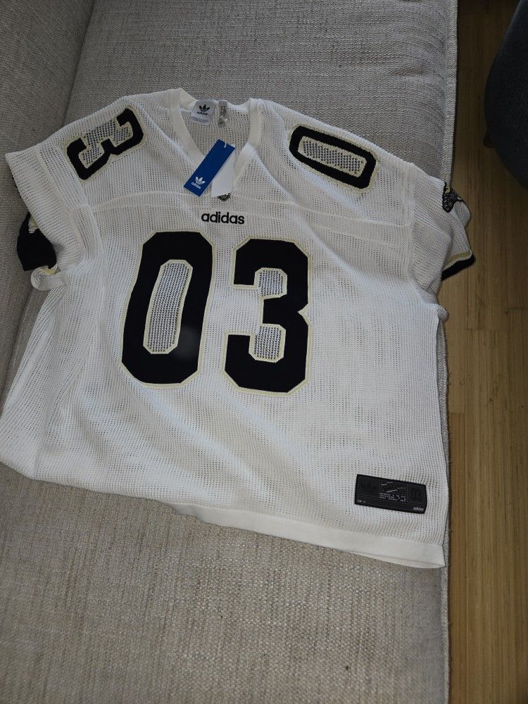 White Adidas sports jersey with black numbers.