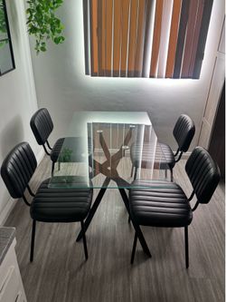Glass dining table, black leather dining chairs-set of 4. PICK UP ONLY.