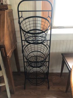 Black metal basket storage tower