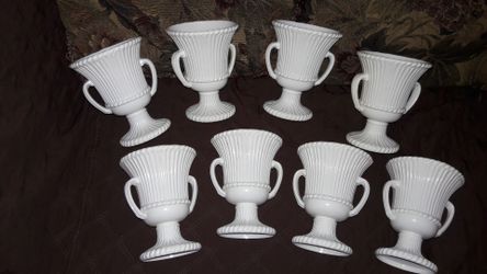 8 white plastic flower vases for $10