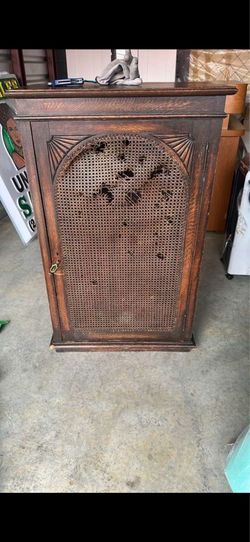 From the photos, this appears to be an antique oak cabinet with a cane (woven) door panel
