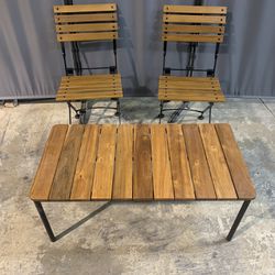 Six Folding Chairs And One Bistro Table