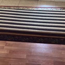 Cushioned bench with wood carvings