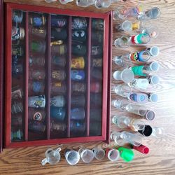 Collection of 95 shot glasses and display case