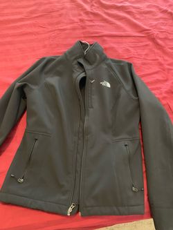 Woman’s The North Face brand zippered jacket, size Medium, black Weather resistant fabric, pockets, warm lining