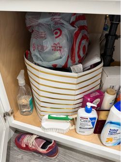 Two matching gold and white striped storage bins