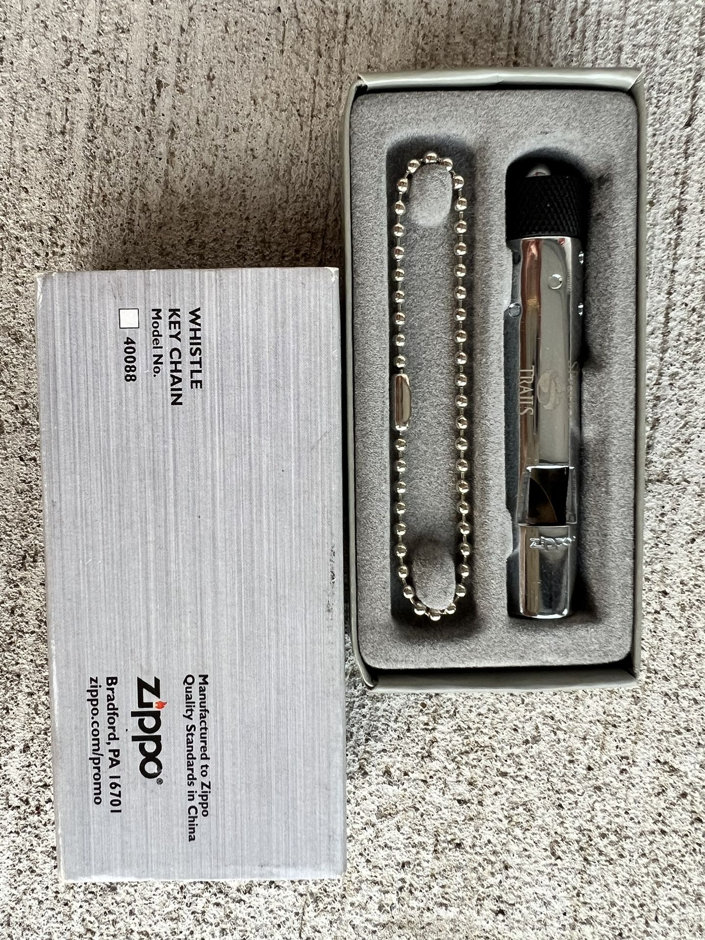 For sale is a brand new genuine Zippo Whistle Keychain, model number 40088, complete in its original box and packaging