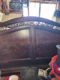 Dark Wood Headboard with Ornate Scrollwork
