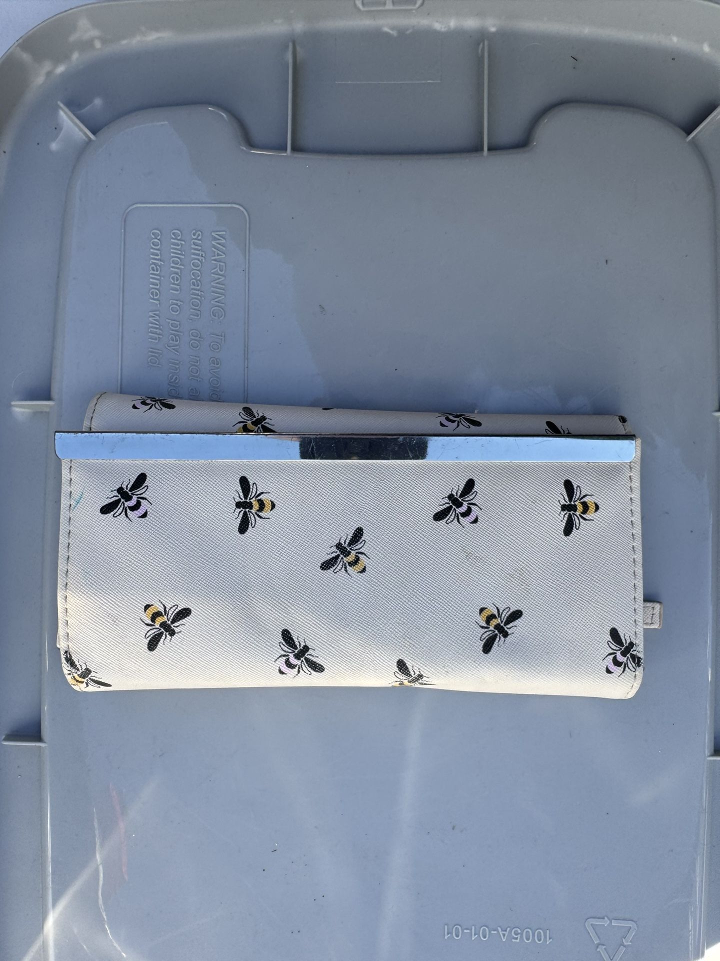 white wallet with a bee print