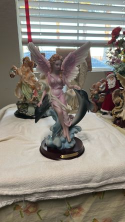 Pink Angel Sitting With Dolphins 