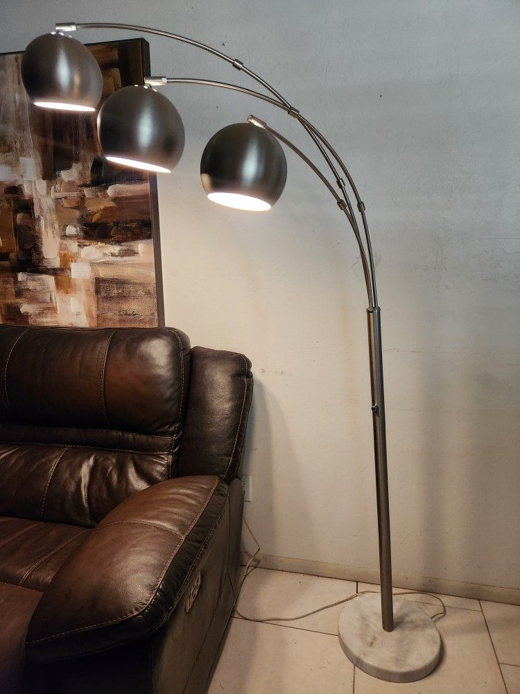 3-light arc floor lamp with metal shades and a marble base