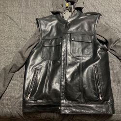 Size Large. Black leather motorcycle vest with concealed gun pockets