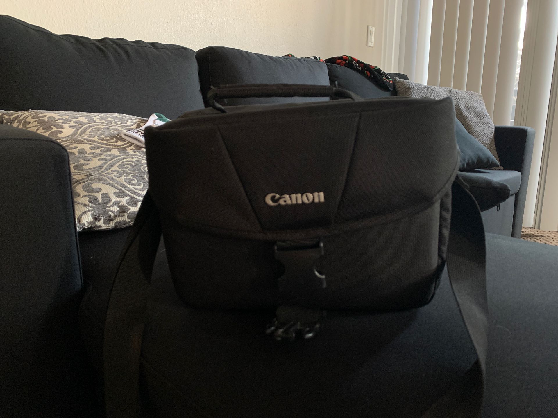 Canon Camera Bag with extra battery, lens supplies and mini tripod