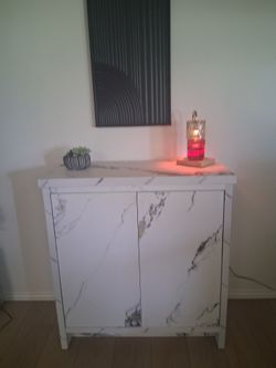 Newly assembled faux marble cabinet $70