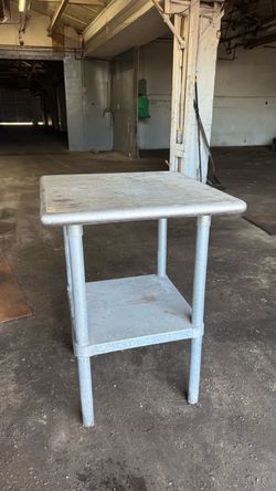 Working bench stainless steel top and galvanized legs and shelf.