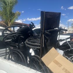 A bunch of wheelchairs different sizes different wheelchairs six of them