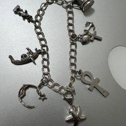 HEAVY STERLING SILVER BRACELET WITH MULTIPLE CHARMS EVERY CHARMS ARE MARK WITH 925 SIZE 7.5