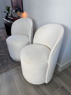 Two Arhaus Kira Swivel Chairs