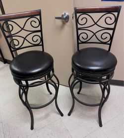Two tall swivel barstools sold as a pair