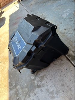 Rzr  cooler has crutches on it and has all the brackets to hook it up