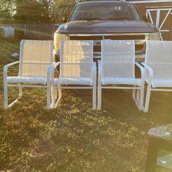 Four Heavy Duty Stackable Chairs.