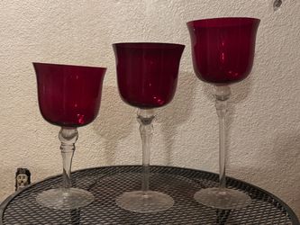 Set of three ruby red glass trumpet candle holders