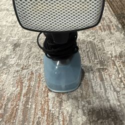 Compact handheld garment steamer with cord.