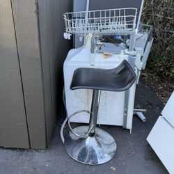 Chrome bar stool with black plastic seat and foot rest.