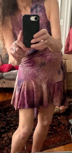 Free People Tie Dye Chevron Textured Wrap Tunic Mini Dress. It features a plunging halter V-neckline, an overlapping wrap bodice, a ruffled flounce he