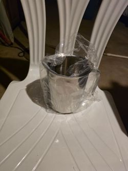 Stainless steel wine chiller with handle.