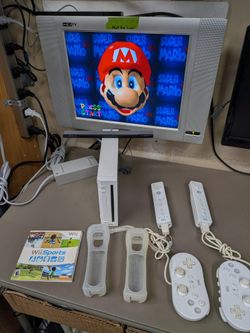White Nintendo Wii with 2 remotes, classic controllers Wii sports also has Mario 64 loaded on system