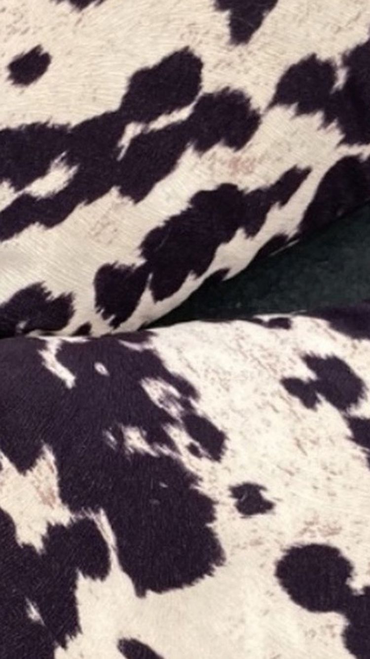 Two cow printed pillows 