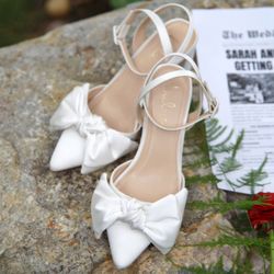 OUT OF STOCK ON WEBSITE - Lulu’s Suttonn Ivory Satin Bow Ankle Strap Pointed-Toe Pumps
