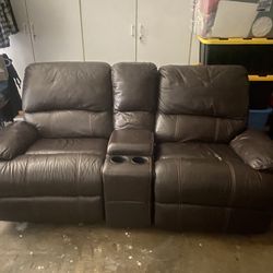 Brown Real Leather Recliner With Center Cup Holders And A Opening For Remotes 