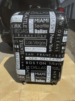 it luggage brand suitcase, specifically the Imprint model featuring a city-themed graphic design