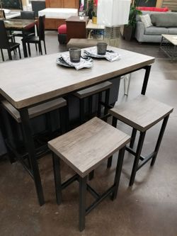 Grey counter height table with 4 stools