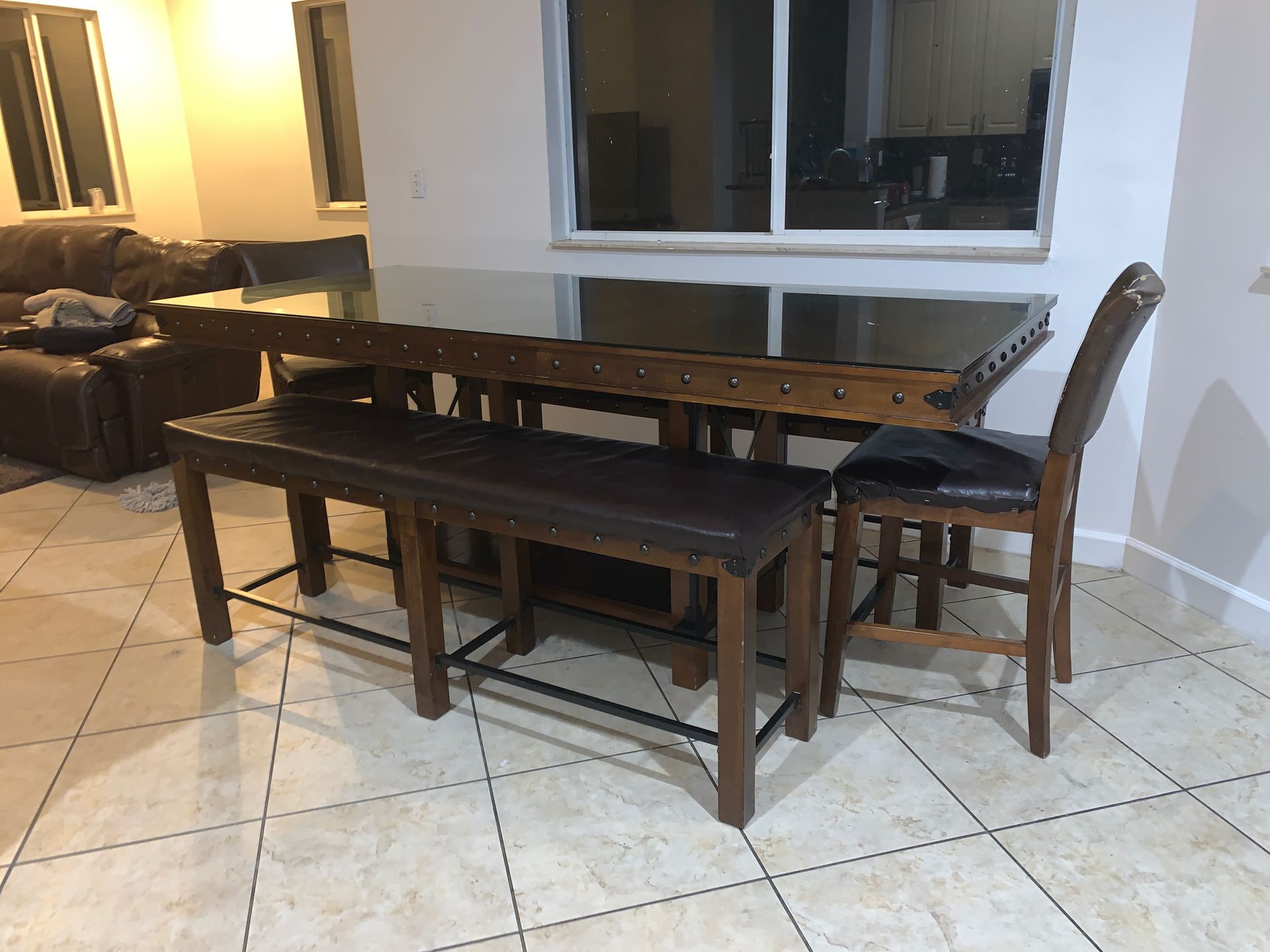 Very tall dining wood table with glass top 2 benches and 2 stools