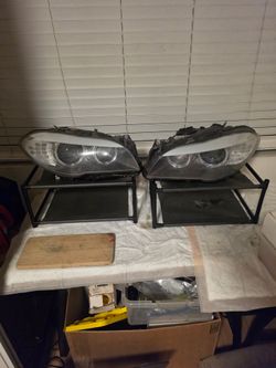 Pre-LCI Xenon (or Bi-Xenon Adaptive) headlight assemblies for a 2011–2013 BMW 5-Series (F10/F11 chassis)