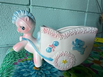 Vintage nursery baby planter in pastel colors . Pony pulling a baby carriage