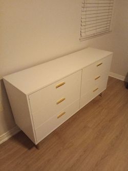 White dresser with gold accents